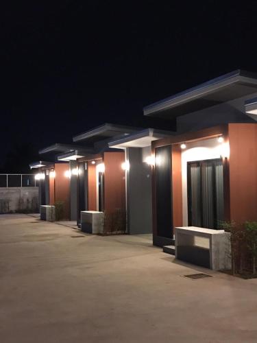 a row of buildings lit up at night at Baan Le Vimaan in Nakhon Ratchasima