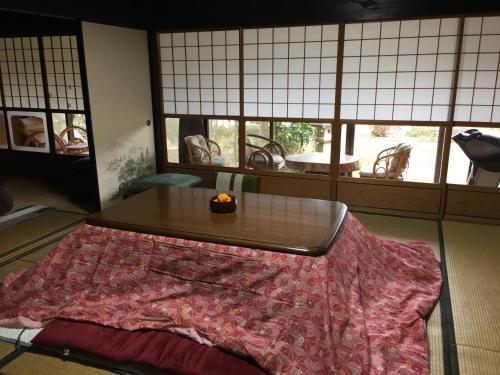 a living room with a table and a table sidx sidx sidx at Tokuheian in Kyoto