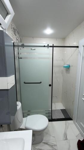 a bathroom with a toilet and a glass shower at Allaoua in Stamboul