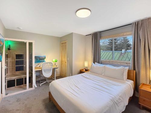 a bedroom with a bed and a desk and a window at 1 Block from Main St Views Pets Okay in Leadville
