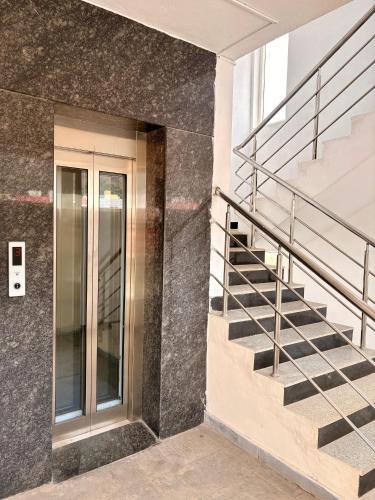 a building with a staircase and a glass door at The capital hotel in Visakhapatnam