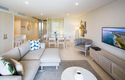 a living room with a couch and a table at Breeze Mooloolaba, Ascend Hotel Collection in Mooloolaba