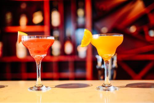three cocktails sitting on top of a table at Bella Vita Hotel in Long Hai
