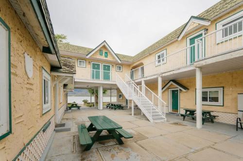 a patio of a building with a picnic table and stairs at 1 BR Suite 9 at Green Gables Resort in Osoyoos