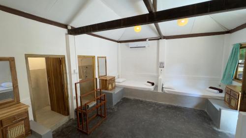 a large white room with a sink and a toilet at Arne's Place in Arugam Bay