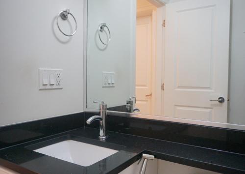 a bathroom with a sink and a mirror at the blossom stay in Burnaby