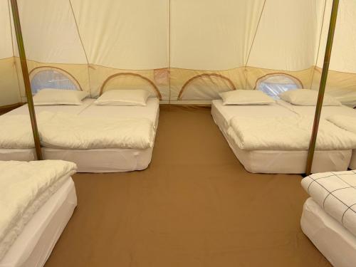 a room with three beds in a tent at Casa Alexia in Potoc