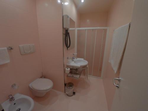 a bathroom with a toilet and a sink at Hotel Ada in Milan