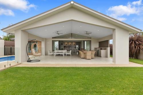 a house with a large patio with a yard at Woodbine Waters Lakehouse in Yarrawonga