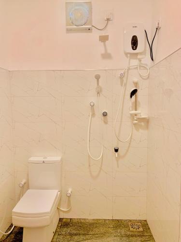a bathroom with a shower stall with a toilet at Royal Palms Resort in Arugam Bay