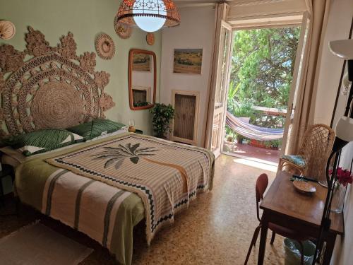 a bedroom with a bed and a table and a window at Casa Orso in Abbadia Lariana