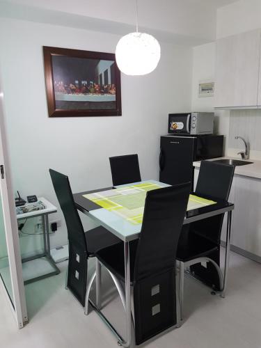 a kitchen with a table and chairs in a room at Azure Tropical Paradise in Manila