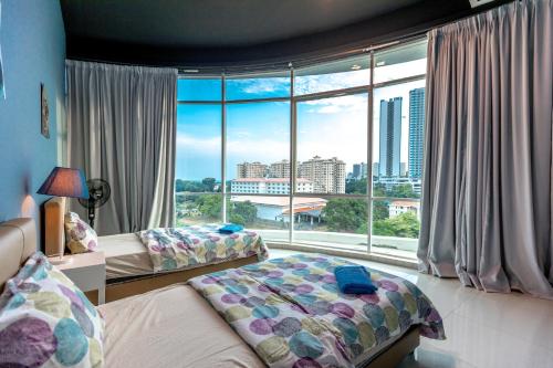 a bedroom with two beds and a large window at Cozy Home with Spectacular View in Bayan Lepas