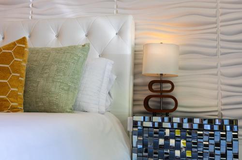 a bedroom with a bed with a lamp on a night stand at Private Luxury Retreat with Kitchen Near SF & Wine Country in San Rafael