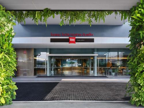 a building with a sign that reads browse better living country at ibis Bangkok IMPACT in Nonthaburi