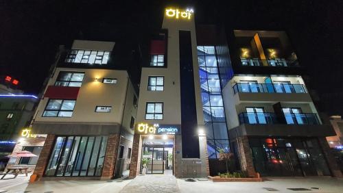 a building at night with snow in front of it at Haha pension in Boryeong