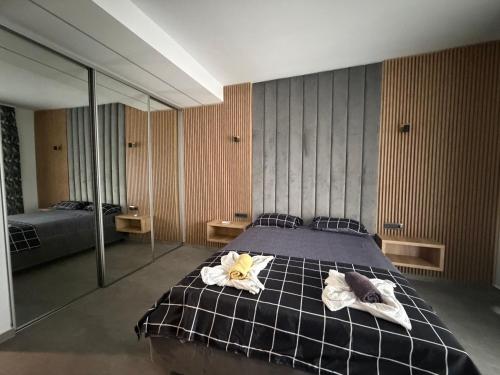 a bedroom with a bed with towels on it at Grand Panorama Residence in Mamaia