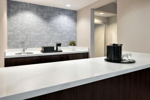 a kitchen with a white counter and a sink at Chicago Marriott Suites Deerfield in Deerfield