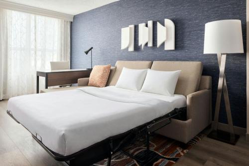 a bedroom with a large bed and a desk at Chicago Marriott Suites Deerfield in Deerfield