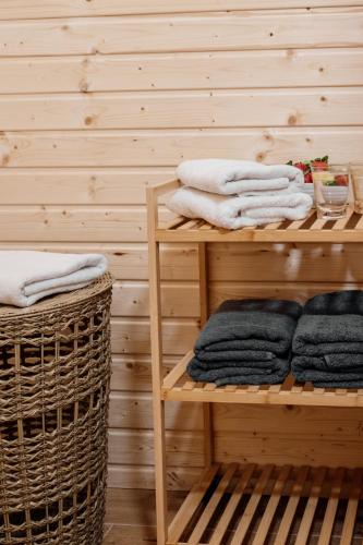 a room with wooden shelves with towels and baskets at Mountain Chalet Donovaly with Sauna & Jacuzzi in Donovaly