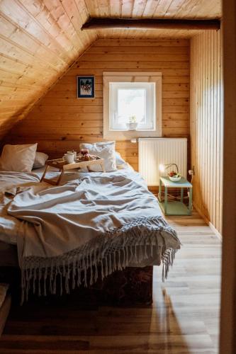 a bedroom with a large bed with a wooden ceiling at Mountain Chalet Donovaly with Sauna & Jacuzzi in Donovaly