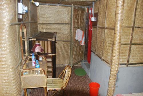 a room with a table and chairs in a room at Hilltop Lodge in Guwahati