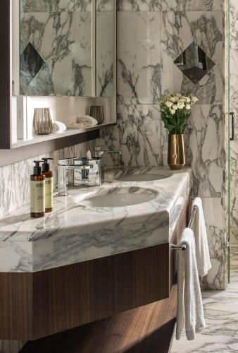 a bathroom with a marble sink and a mirror at ME by Meliá Milan Il Duca in Milan