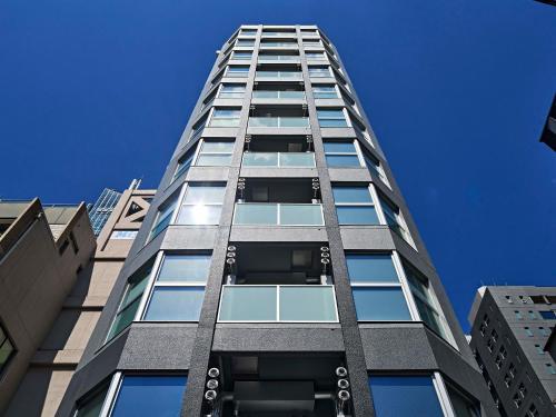 a tall building with windows on the side of it at TORANOMONHOLIC Hotel in Tokyo