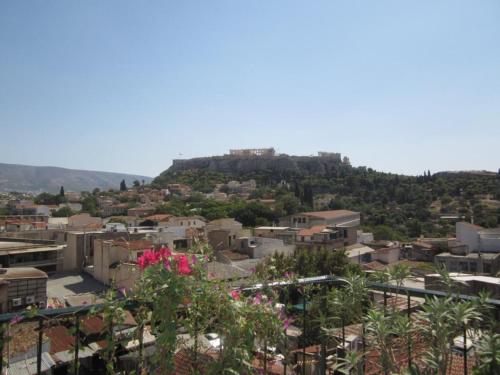 a view of a city with a hill in the background at Pella Inn Hostel in Athens