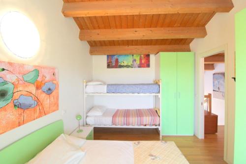 a bedroom with a bunk bed and a painting on the wall at Oasis Blue Resort - Hotel & Residenz Apartments Strandnähe in Caorle