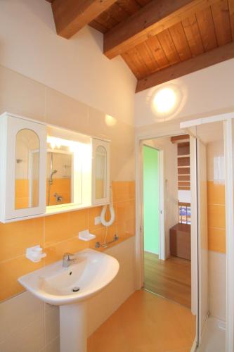 a bathroom with a sink and a mirror at Oasis Blue Resort - Hotel & Residenz Apartments Strandnähe in Caorle