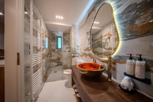 a bathroom with a sink and a mirror at Leon Suites Nemea in Neméa