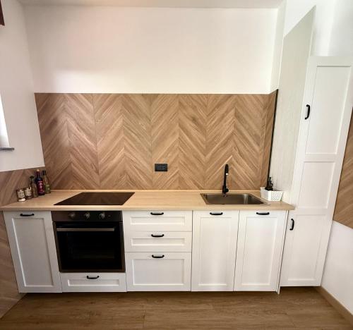 a white kitchen with a sink and a stove at INCLUSIVeLOFT in Legnano