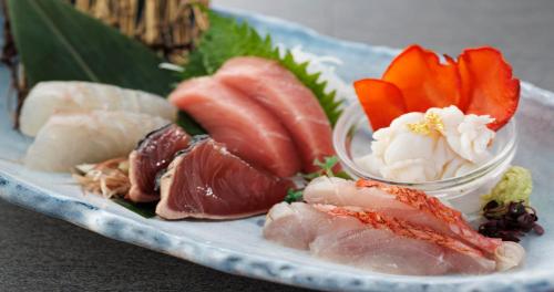 a plate of food with sushi and meats on it at Wan Wan Paradise Izukogen in Ito