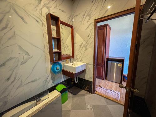 a bathroom with a sink and a mirror at NamKhan Riverside in Luang Prabang