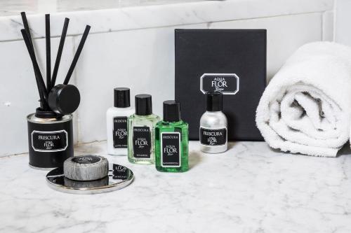a group of four bottles of hair products on a counter at Hotel Burchianti in Florence