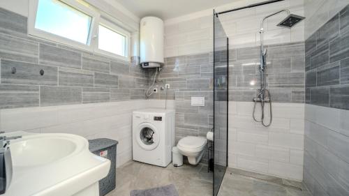 a bathroom with a shower toilet and a sink at Villa Rab Paradise pool by Villas Guide in Lopar