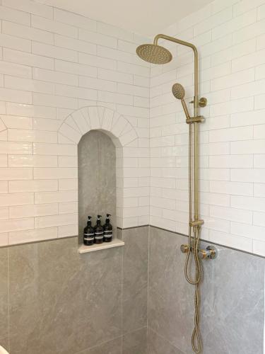 a shower in a bathroom with a glass door at Pennkiat House in Bangkok