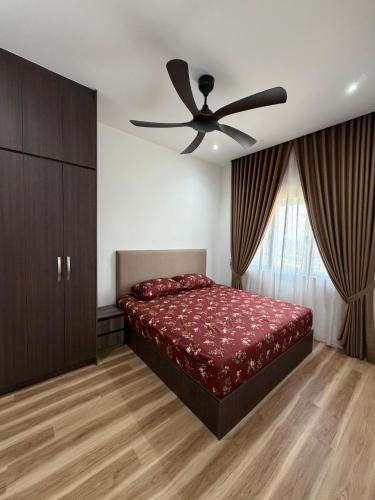 a bedroom with a bed and a ceiling fan at Sufi Islamic Homestay for Islamic only in Nilai
