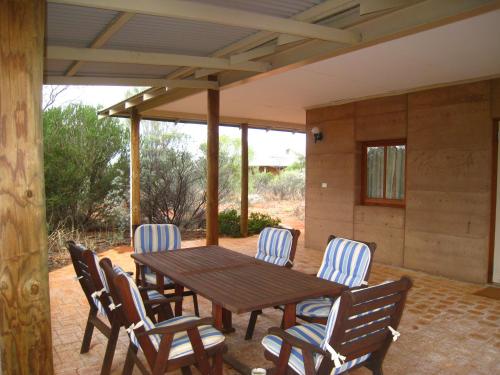 a wooden table and chairs on a patio at Wooleen Station in Wooleen