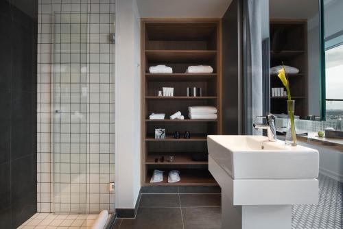 a bathroom with a sink and a shower at Meliá Paris La Défense in Courbevoie