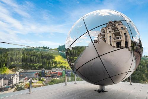 a large metal ball sitting on top of a building at MARION SPA Hotel in Bukovel