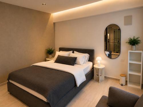 a bedroom with a large bed and a mirror at Dizengoff Square Garden - by BAR COLLECTION in Tel Aviv