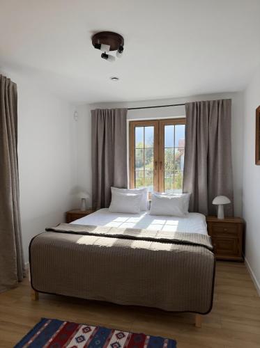 a bedroom with a bed and a window at Sielski Dom in Suwałki