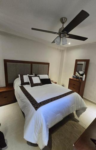 a bedroom with a large bed with a ceiling fan at Apartment with separate parking in Heroica Nogales