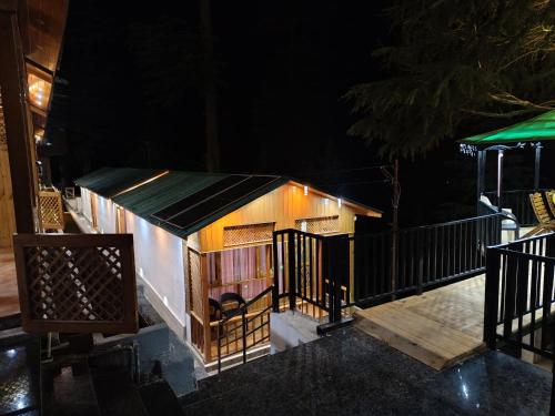 a small house with a gate at night at Bhaderwah Resorts Pvt Ltd in Dranga