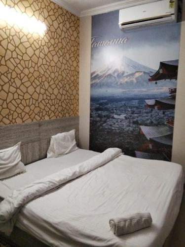 a bedroom with two beds with a painting on the wall at hotel tamanna in Lucknow
