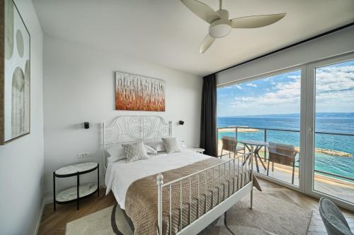a bedroom with a bed and a view of the ocean at STELLA'S BEACHFRONT - Aparthotel - FREE PARKING in Split
