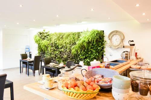 a kitchen with a table with food on it at Les Granges d'Haillancourt in Ivry-le-Temple