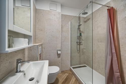 a bathroom with a shower and a sink and a toilet at STELLA'S BEACHFRONT - Aparthotel - FREE PARKING in Split